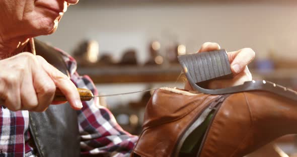 Shoemaker repairing a shoe