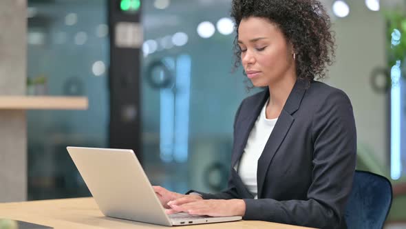 Young African Businesswoman Smiling at Camera at Work