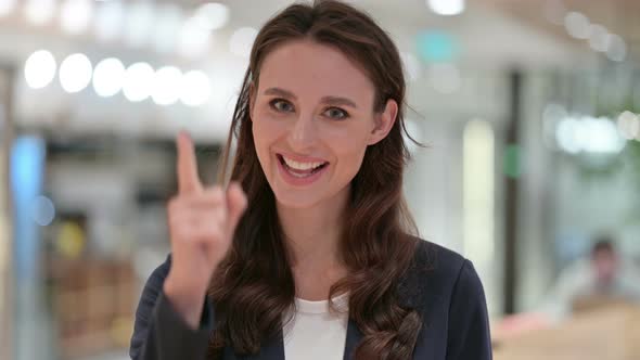 Portrait of Smiling Businesswoman Pointing at the Camera