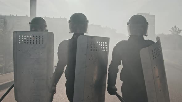 Riot Police Officers with Shields and Batons