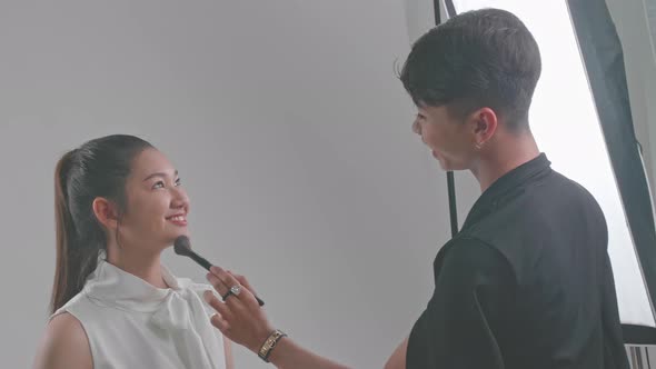 Backstage Of The Photo Shoot: Make-Up Artist Applies Makeup On Beautiful Asian Model