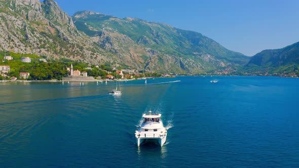 Sailing Yacht in the Sea in the Distance you Can See the Coast with Mountains in Kotor Bay