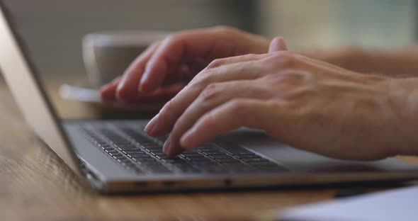 Man's Hands Typing on Laptop