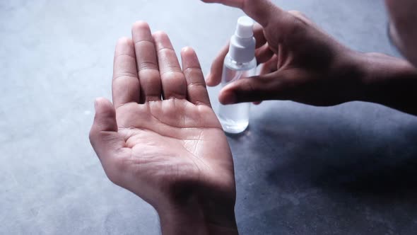 Close Up of Young Man Hand Using Hand Sanitizer Spray.