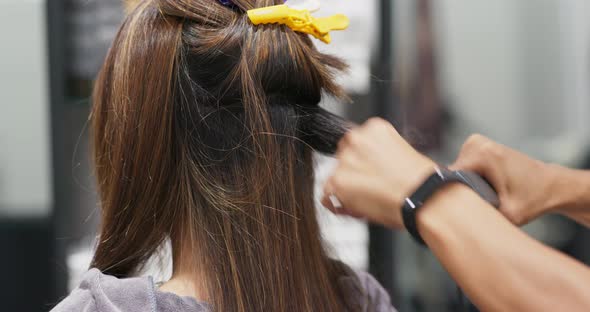 Woman have straight hair treatment in hair salon