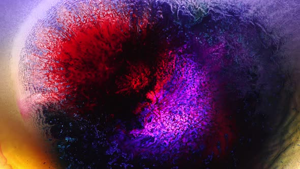 Neon red purple vivid colors ink and shiny particles macro. Liquid abstract painting