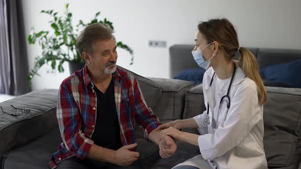 Doctor Measure Pulse of Senior Man at Home