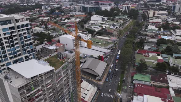 Drone shot of a tower crane constructing a high rise building in San Jose city