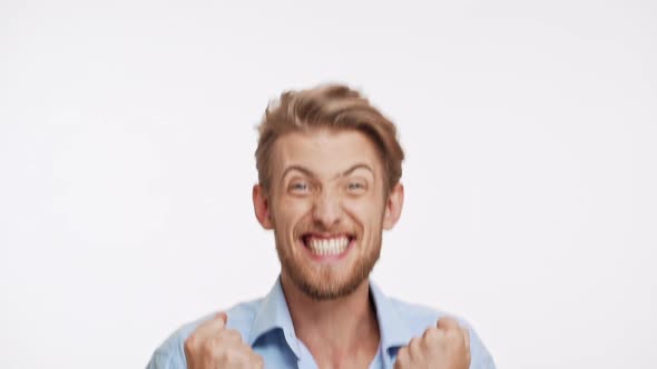 Caucasian Young Man with Brown Beard and Blue Eyes Showing Very Actively Yes on White Background