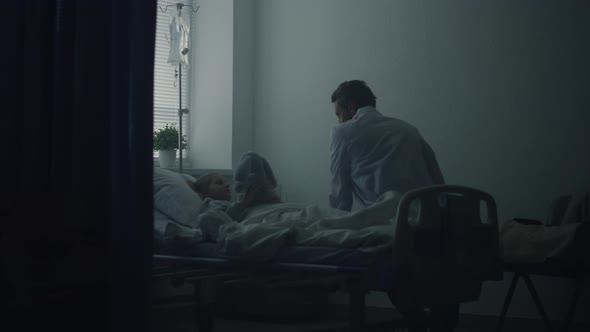 Doctor Visiting Little Patient in Clinic Ward