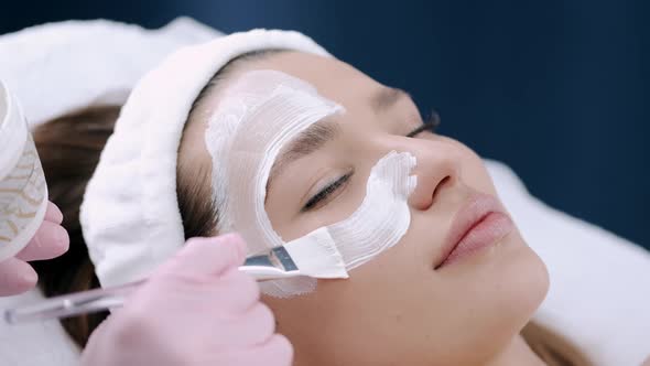 Cropped View of Beautician Putting Facial Mask on Face