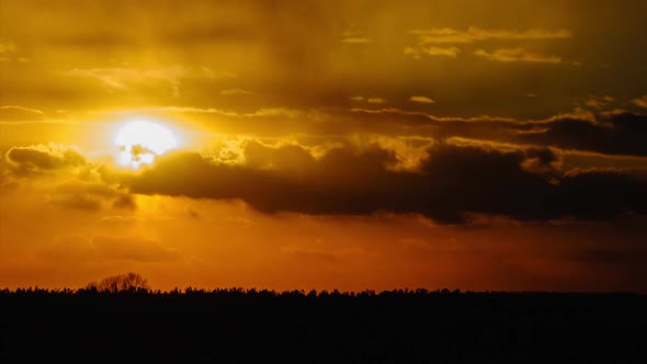 Sunset in the Sky Through Yellow Layered Clouds Timelapse