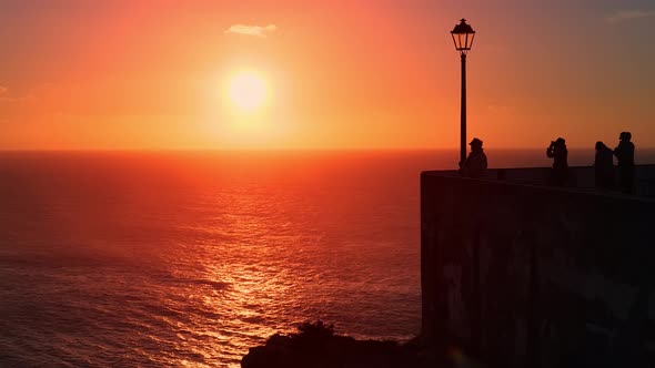 Toutist Enjoys the View From the Miradouro Do Nazare at Sunset