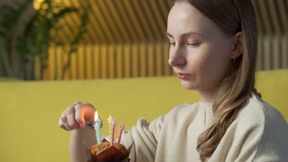 Woman Lights a Candle on a Delicious Cake