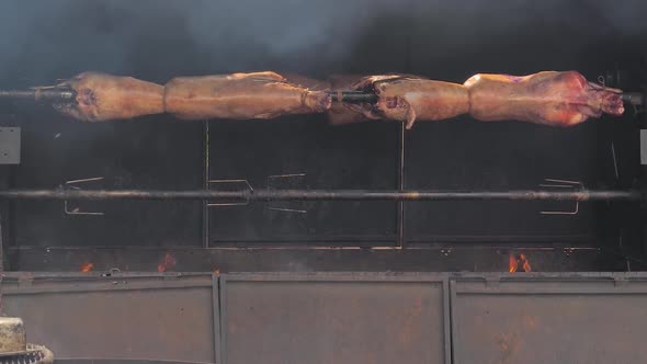 Slow Motion Cooking Ram Carcasses on Spit at Summer Street Food Market