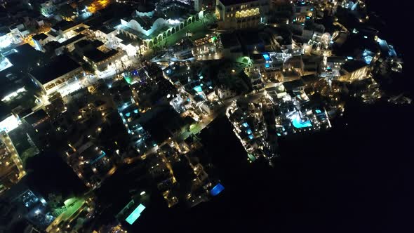 City of Santorini by night on the island of Santorini in Greece from the sky