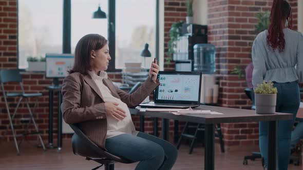 Woman Expecting Child Holding Smartphone to Talk on Video Call