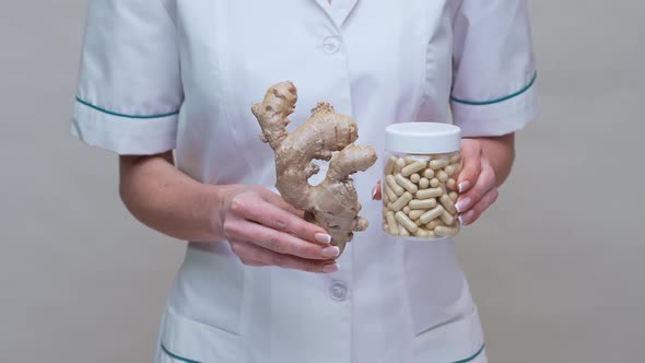 Nutritionist Doctor Healthy Lifestyle Concept - Holding Ginger Root and Jar of or Vitamine Pills