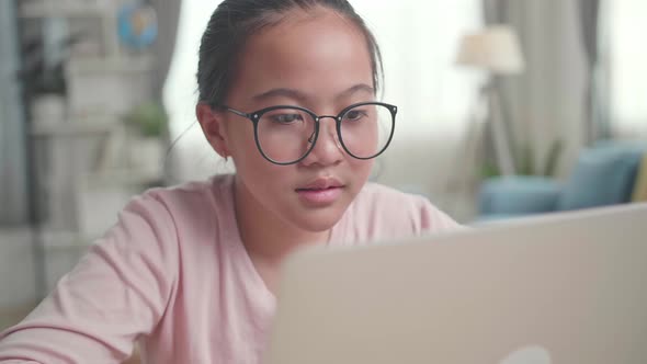 Close Up Asia Teenage Girl Learning Online From Laptop At Home