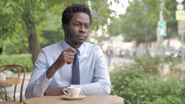 Headache Stressed African Businessman Sitting in Outdoor Cafe