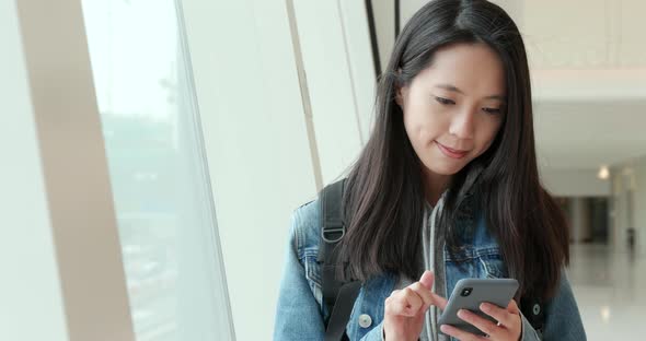 Young Woman use of smart phone in shopping mall