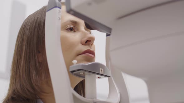 Woman Having Slit Lamp Eye Exam in Optometry Office