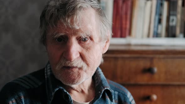 Portrait of Emotional Senior Man at Home. Happy Male Person with Grey Hair Looking Behind. Joyful