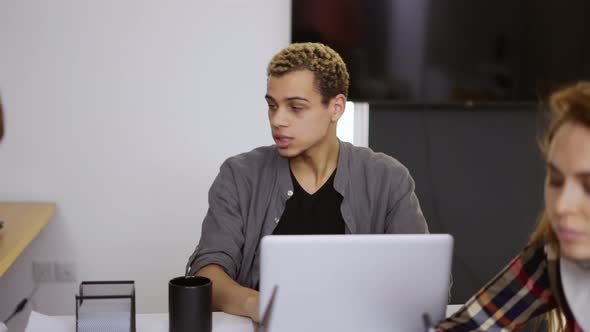 Young Business Coworkers in the Office Mixed Race Man Has a Video Conference
