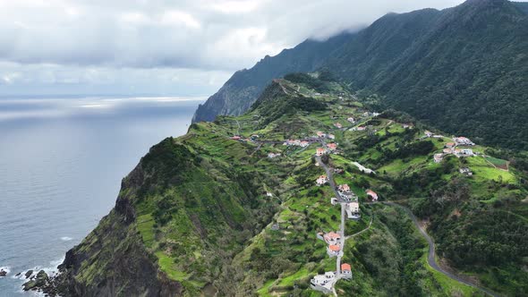 Village situated in rugged mountainous landscape, Porto da Cruz, Madeira; aerial