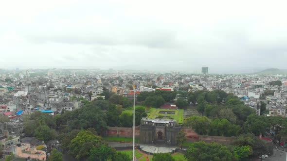 Dolly back drone shot over Shaniwar wada traffic on Chhatrapati Shivaji bridge road Dr Hegdwar chowk