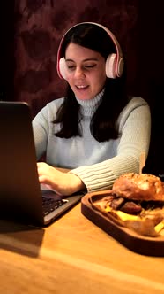 Woman Freelancer Working in Cafe Listening Music in Headset