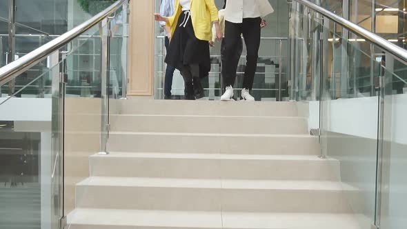 Group of Cheerful Students After Training Cheerfully Descend the Stairs, Walk Along the Corridor
