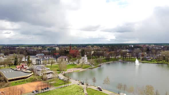 City skyline of Druskininkai in aerial view with dark stormy clouds