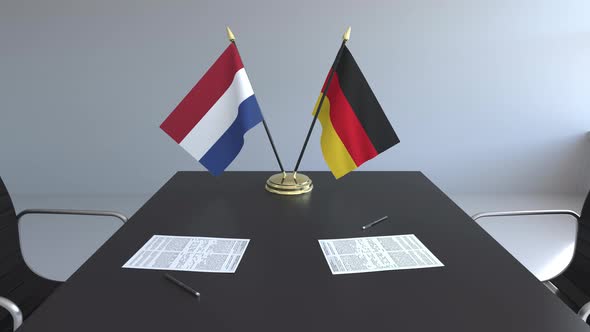 Flags of the Netherlands and Germany and Papers