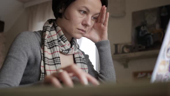 The Girl Is a Student Sitting at the Table and Preparing for the Exam