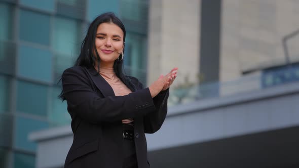 Enthusiastic Young Businesswoman Standing on City Building Backround Smiling Clapping Hands Hispanic