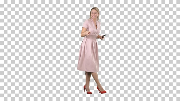 Laughing beautiful young woman in pink dress standing