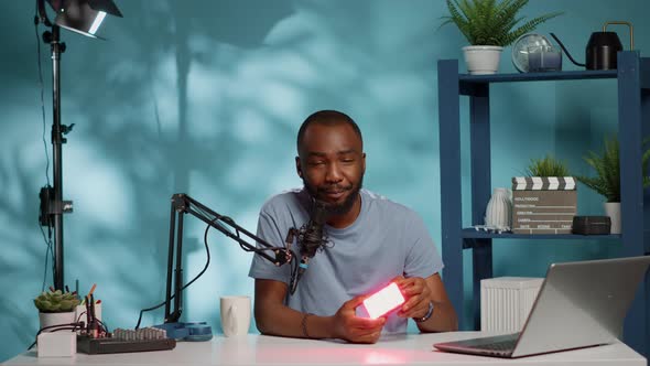 Social Media Influencer Holding White Light for Review on Vlog