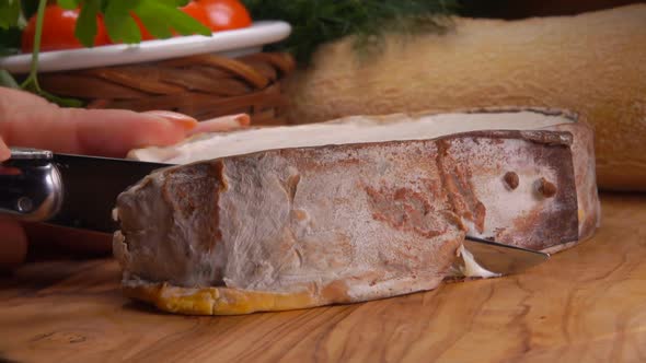 Creamy French Epoisses Cheese Cut on Wooden Board