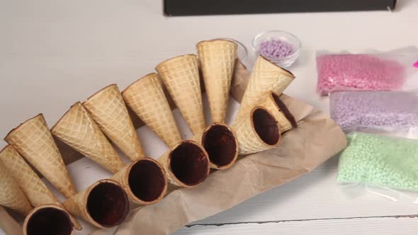 Wafer Cones Smeared Inside With Liquid Chocolate. They Are On Stands.