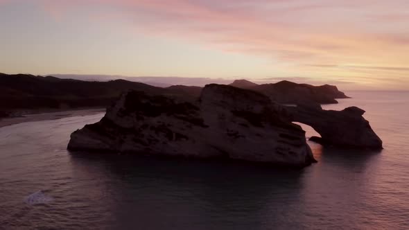 Islet with archway during sunset