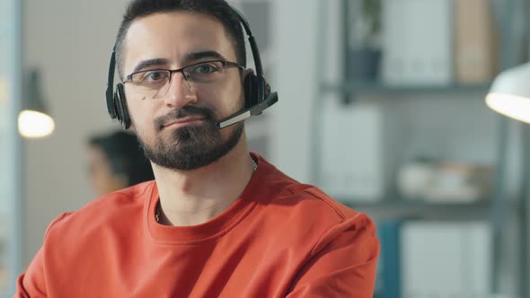 Portrait of Man in Headset at Work in Call Center