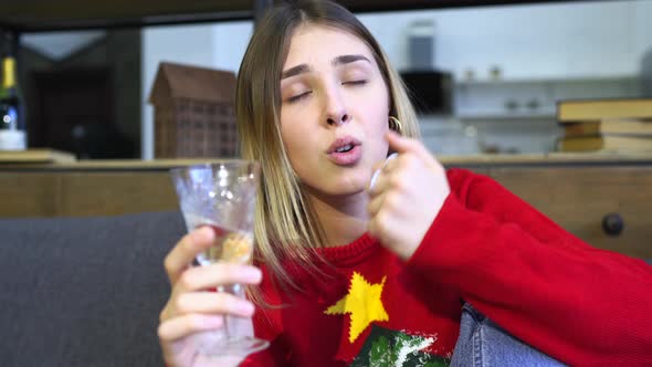 Lady Holding Glass of Champagne While Looking at Camera.