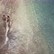 Aerial View of Couple Walking on Tropical Beach - VideoHive Item for Sale