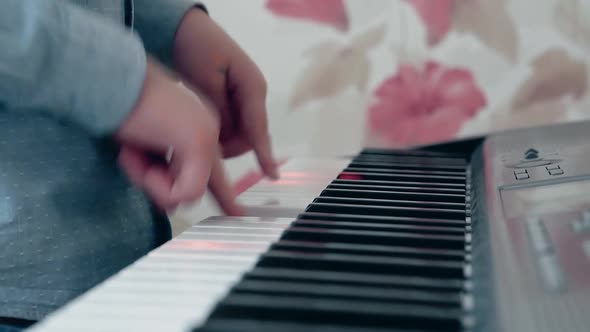 Little Boy Playing on a Musical Synthesizer