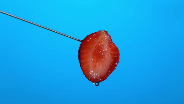 Closeup of Ripe Juicy Strawberries with Drop of Water Flowing Over the Surface