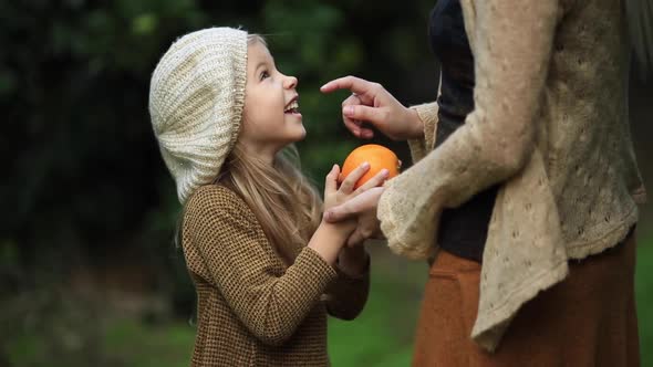 Happy Girl with Mother in Green Garden