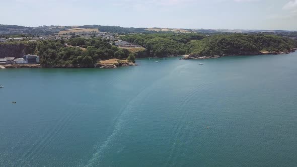 Flying towards the beach of Brixham in England. Beach cove in southwest England.