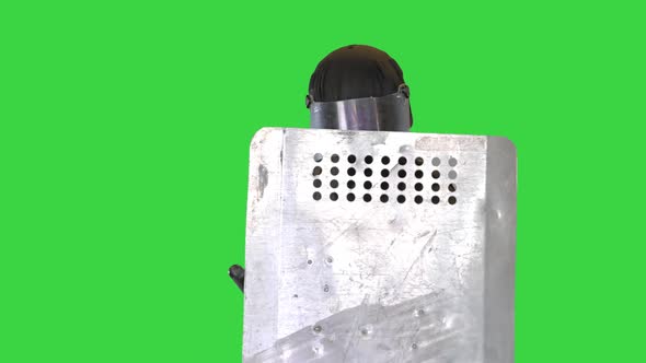 Soldier in Full Uniform Covering with Protective Shield Moving Forward on a Green Screen Chroma Key