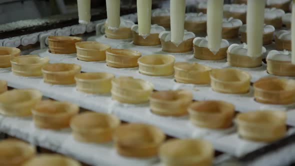 Ice Cream Production Line. Filling of Wafer Cups with Ice Cream in Ice Cream Factory
